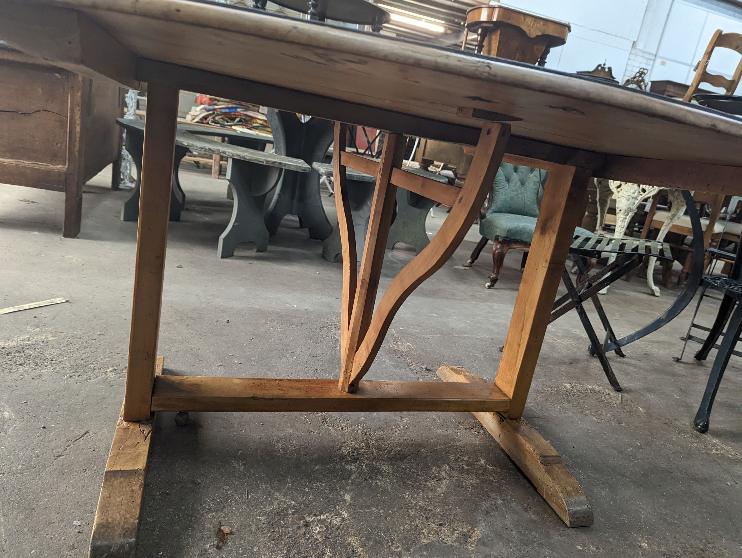A French oval fruitwood Vendange wine tasting table with later painted top, length 174cm, depth 130cm, height 74cm